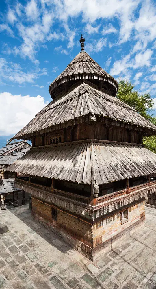 Wooden temple amidst serene mountains.